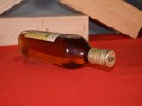 a bottle of alcohol sitting on a table next to a box