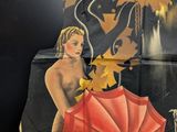 a picture of a woman holding an umbrella on a wall