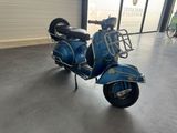 a blue scooter parked inside of a building
