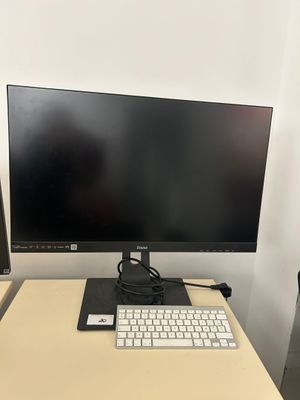 a computer monitor and keyboard on a desk