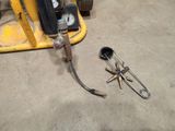 a fork and a wrench on the floor in a garage