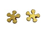 two pieces of gold colored metal on a white surface