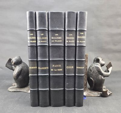 five books sitting on top of each other on a table