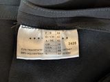 a close up of a label on the back of a black jacket
