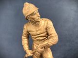 a statue of a man holding a baseball bat