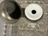 a glass container with a silver lid and a silver lid