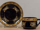 two cups and a saucer sitting on a table