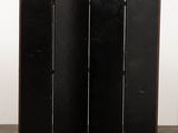 a black folding screen in the shape of a room divider