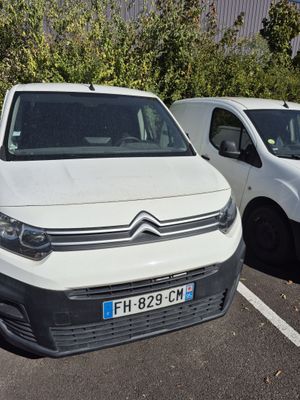 a white van parked next to a white van in a parking lot