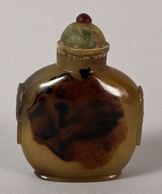 a small glass bottle with a lid on a table
