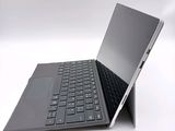 a laptop with a keyboard sitting on top of it