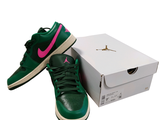 a pair of green and pink shoes next to a box