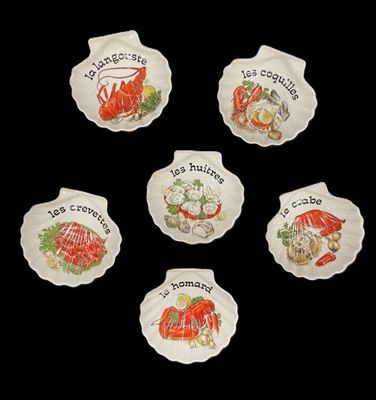 six ceramic plates with different types of food on them on a black background