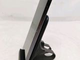 a cell phone that is on a stand on a table
