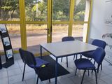 a table and chairs in a room with a large window