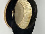 a black hat with a ruffled brimle on top of it