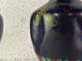two vases that are sitting on a table