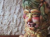 a ceramic statue of a woman with a green head