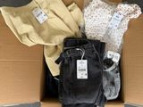 a cardboard box full of clothes and a pair of pants