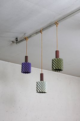 four different colored lights hanging from the ceiling in a room