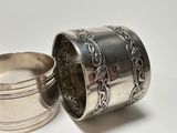 a silver cup and a silver spoon on a white surface