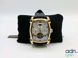 a watch that is sitting on top of a black cloth