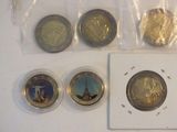 four different coins in the package on the table