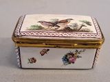 a small box with a bird on it on a table