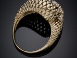 a close up of a gold ring with diamonds on a black background