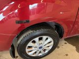 a red car that has a sticker on the side of it