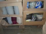 many cups and plates in a cardboard box on the floor