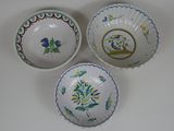 three different types of bowls with designs on them on a white surface