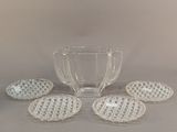 five glass bowls and a pitcher on the table