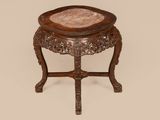 an old wooden table with a marble top on a beige background