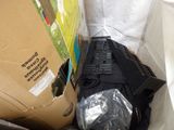 a black laptop sitting inside of a box on the ground