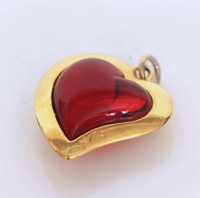 a red glass heart shaped pendant on a gold plated chain