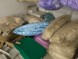 a pile of bags and boxes in the corner of a room