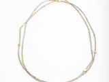 a close up of a necklace on a white background