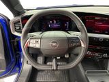 the interior of a car with a steering wheel and dashboard controls