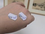 a person holding a piece of paper with writing on it