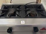 a gas stove that is sitting in a kitchen