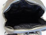 a person holding a silver bag with a zipper
