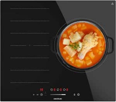 une plaque de cuisson électrique noire sur laquelle est posé un bol de soupe