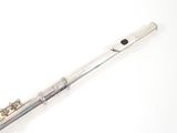 a flute that is sitting on a white surface
