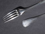a fork and a spoon on a black surface