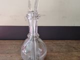 a clear glass vase sitting on a wooden table