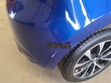 a close up of a blue car with a sticker on the side of it