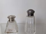 two salt and pepper shakers sitting on a table
