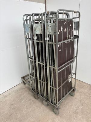 a metal cage with a bunch of luggage in it