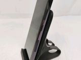a cell phone that is sitting on top of a stand